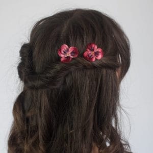 Deep Red, Velvet Pansies, worn with a twisted half up do