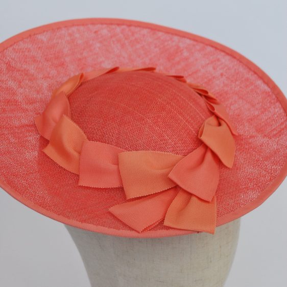 Angled shot, showing small crown of hat and two-tone pink petersham ribbon trim.