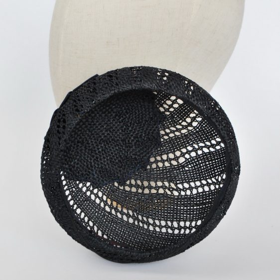 Interior of unlined hat, showing open weave of the straw