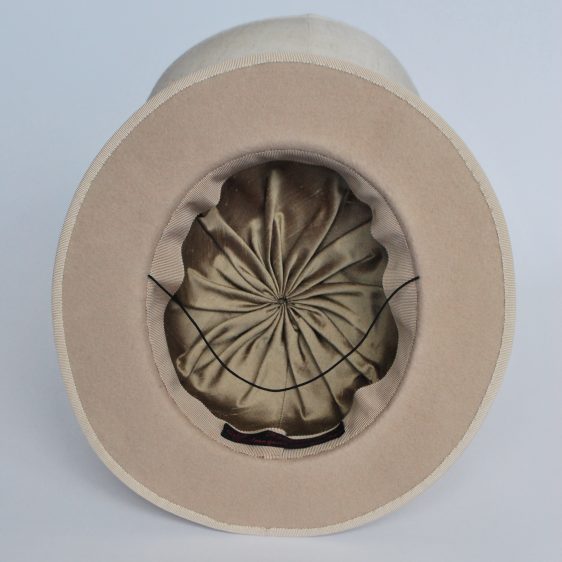 Interior shot, showing the short brim, and the gold silk lining of the piece.