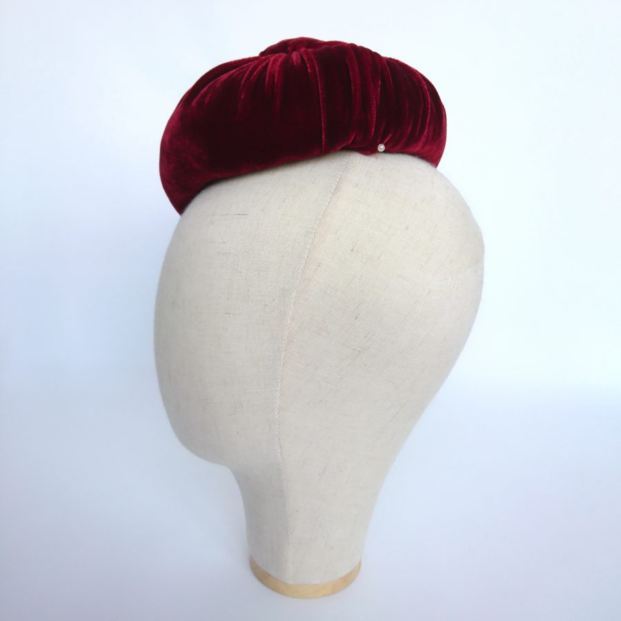 Detail of handmade red velvet hat using traditional millinery techniques