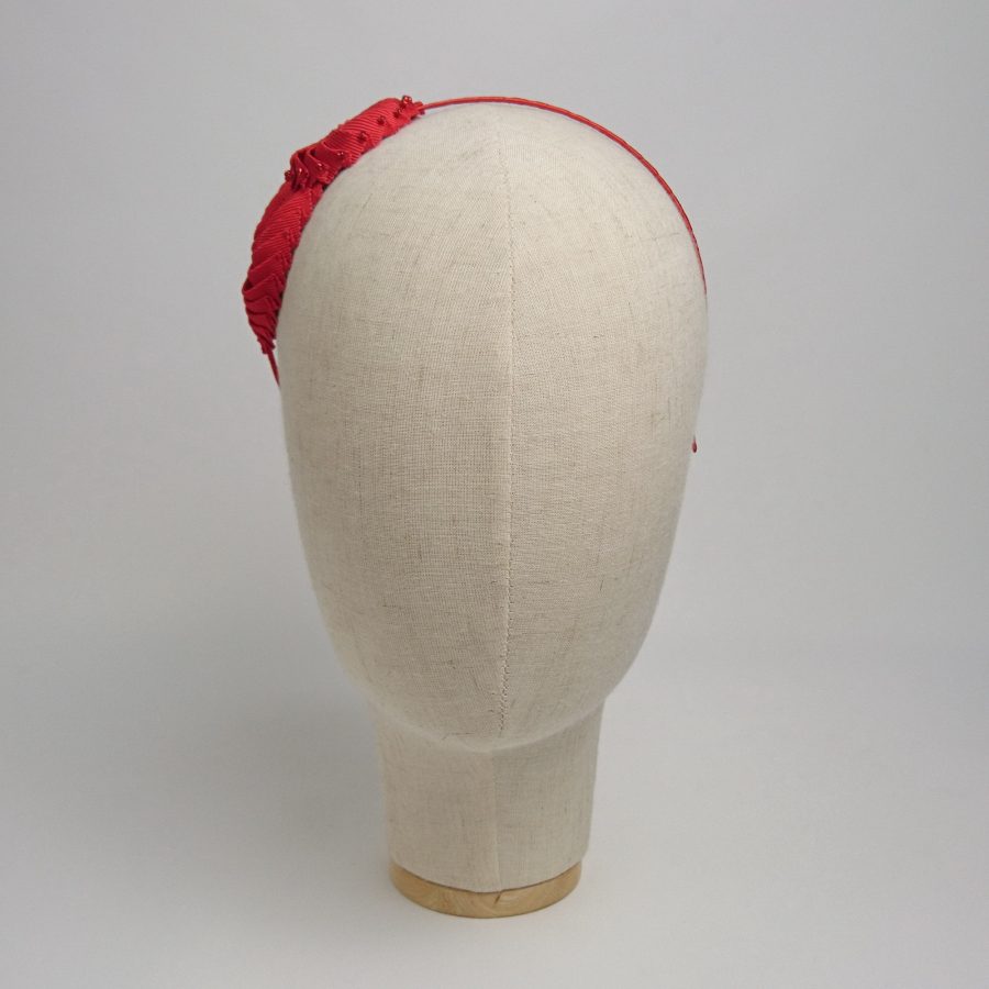 Unique handmade bridal accessories by Imogen's Imagination. Front view of red nautilus shell headband.