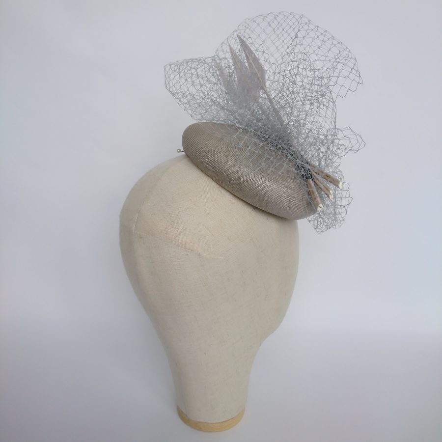 Grey occasion hat with veiling and feathers