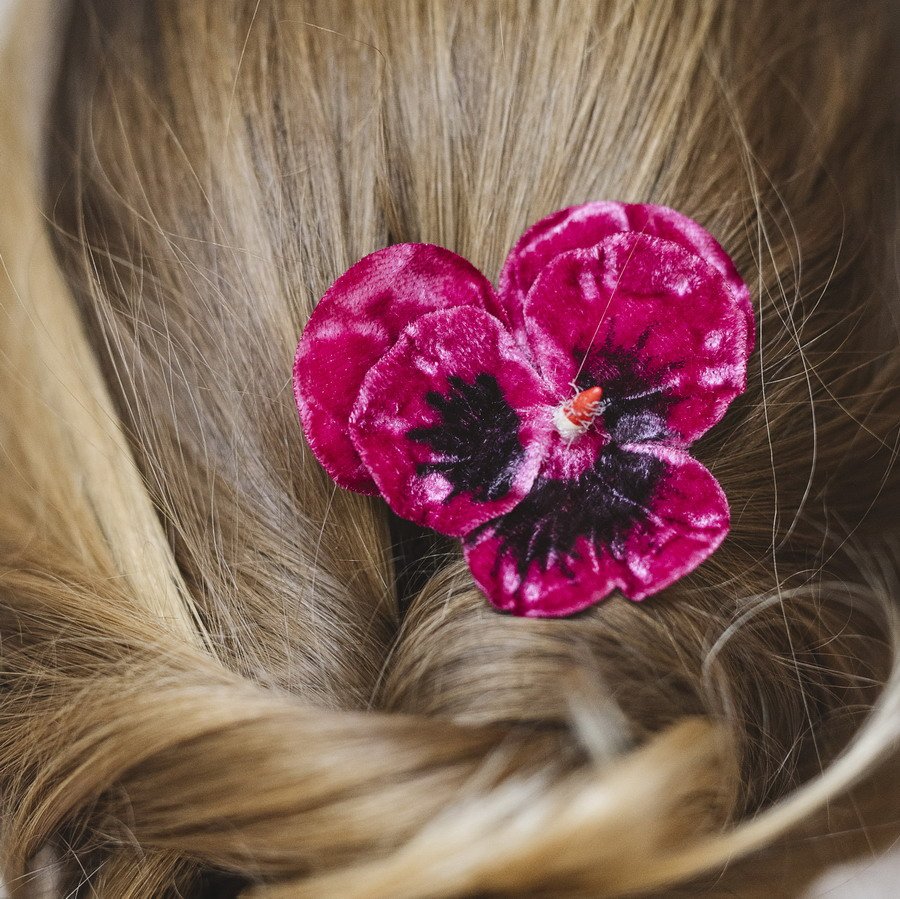 Detail image of Fuchsia Pansy Flower Hair Clip worn with ponytail