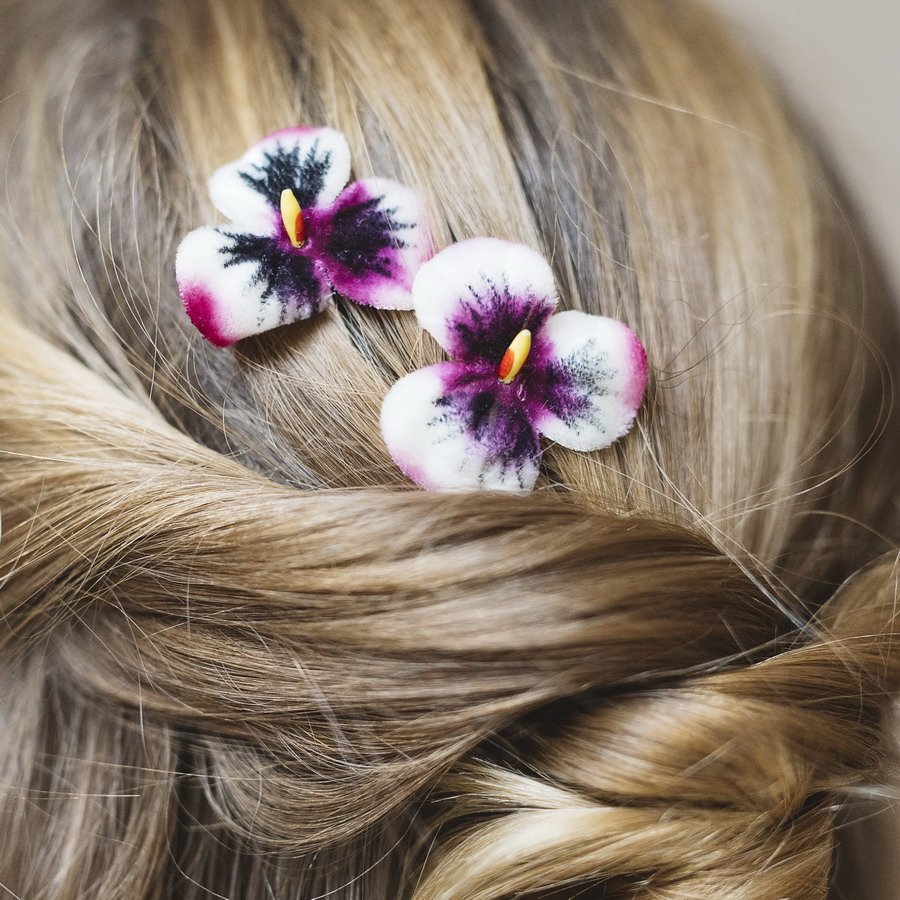 Detail image of Pink White Pansy Flower Hair Clips worn with a twist ponytail