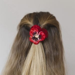 Large Red Pansy Flower Hair Clip worn with a twisted hair style