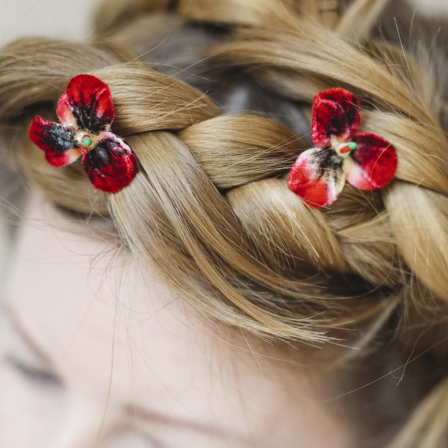 Detail image of Small Red Pansy Flower Hair Pins worn with a halo braid