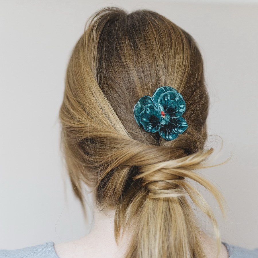 Teal Pansy Flower Hair Clip worn with a ponytail