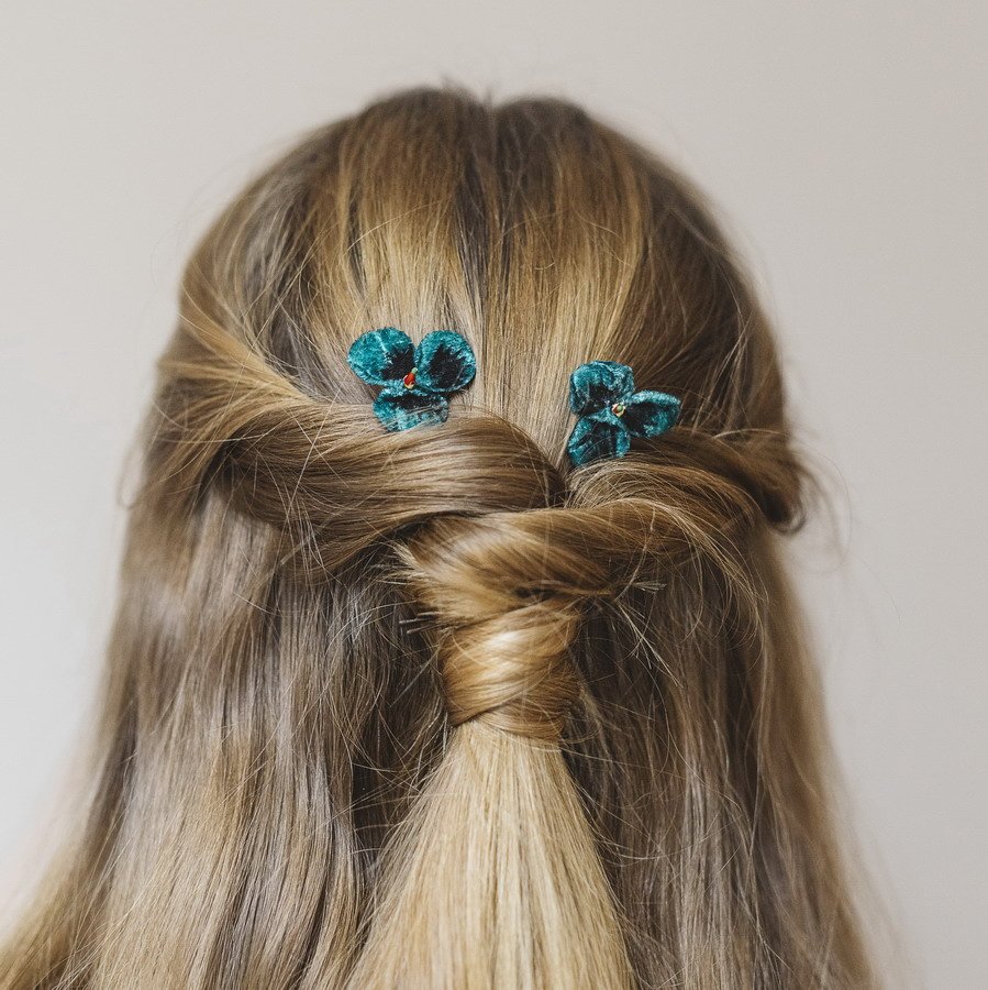 Teal Pansy Flower Hair Clips worn with a twist ponytail