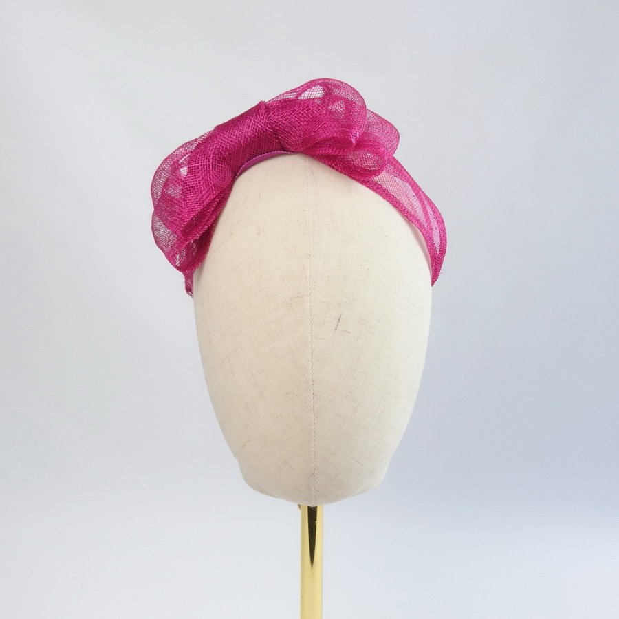 Dark Pink Vegan Friendly Fascinators - Front view of Dark Pink Large Sinamay Bow Fascinator, worn to the right