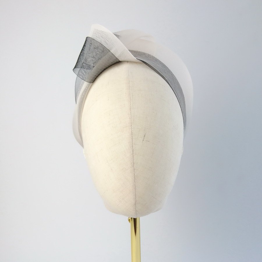 Ivory Black Crinoline Knot Headband worn to the right of the head