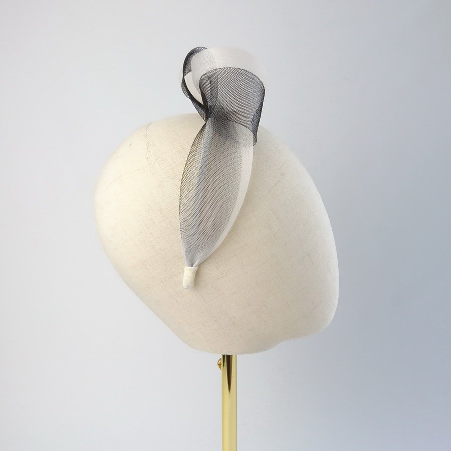 Ivory Black vegan friendly knotted headband worn to the right of the head