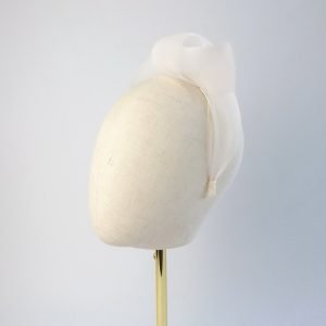 Ivory contemporary headband worn to the left of the head