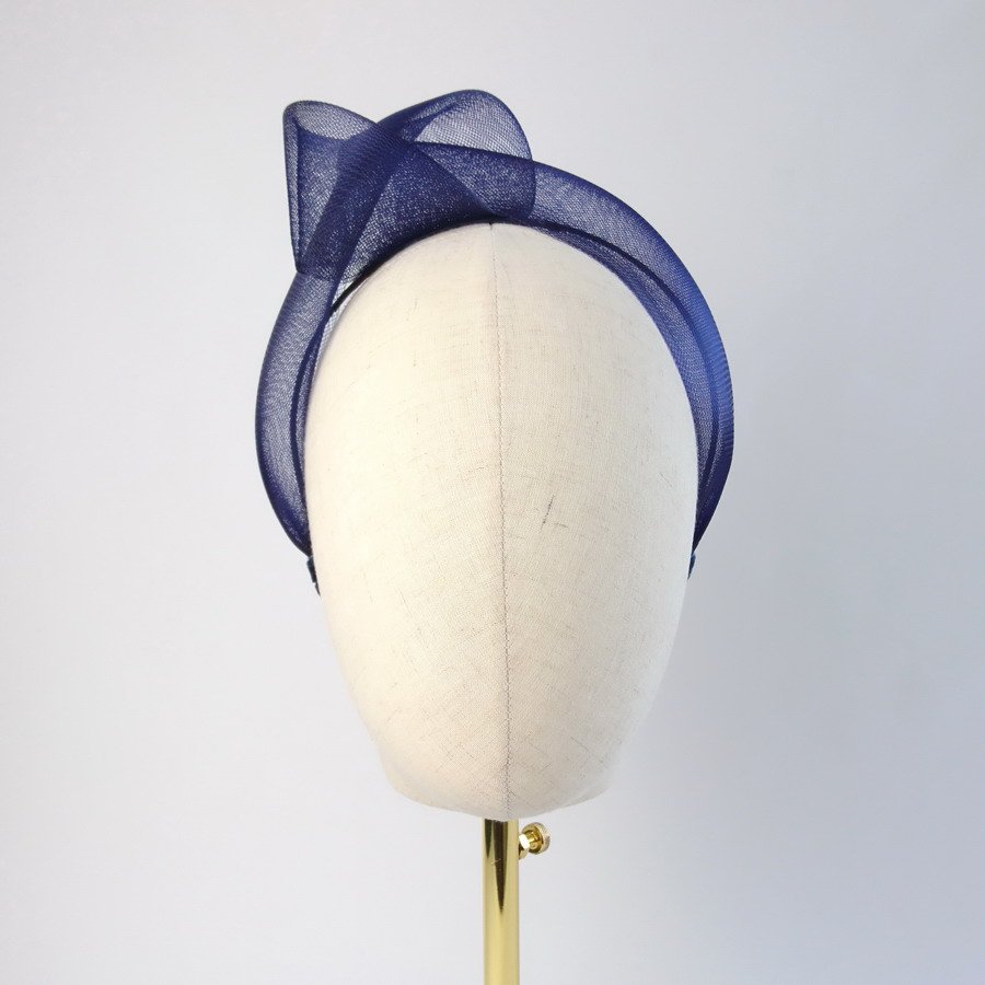 Navy Blue Crinoline Knot Headband worn to the right of the head