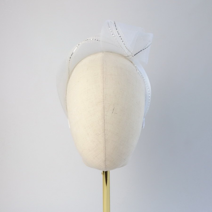 White Silver Crinoline Knot Headband worn to the left of the head