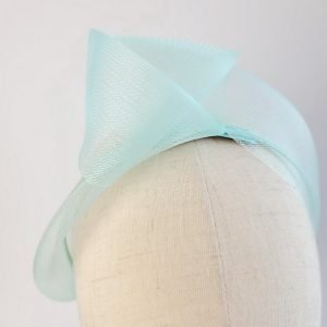 Detail of Aqua Blue Crinoline Knot Headband worn to the right of the head