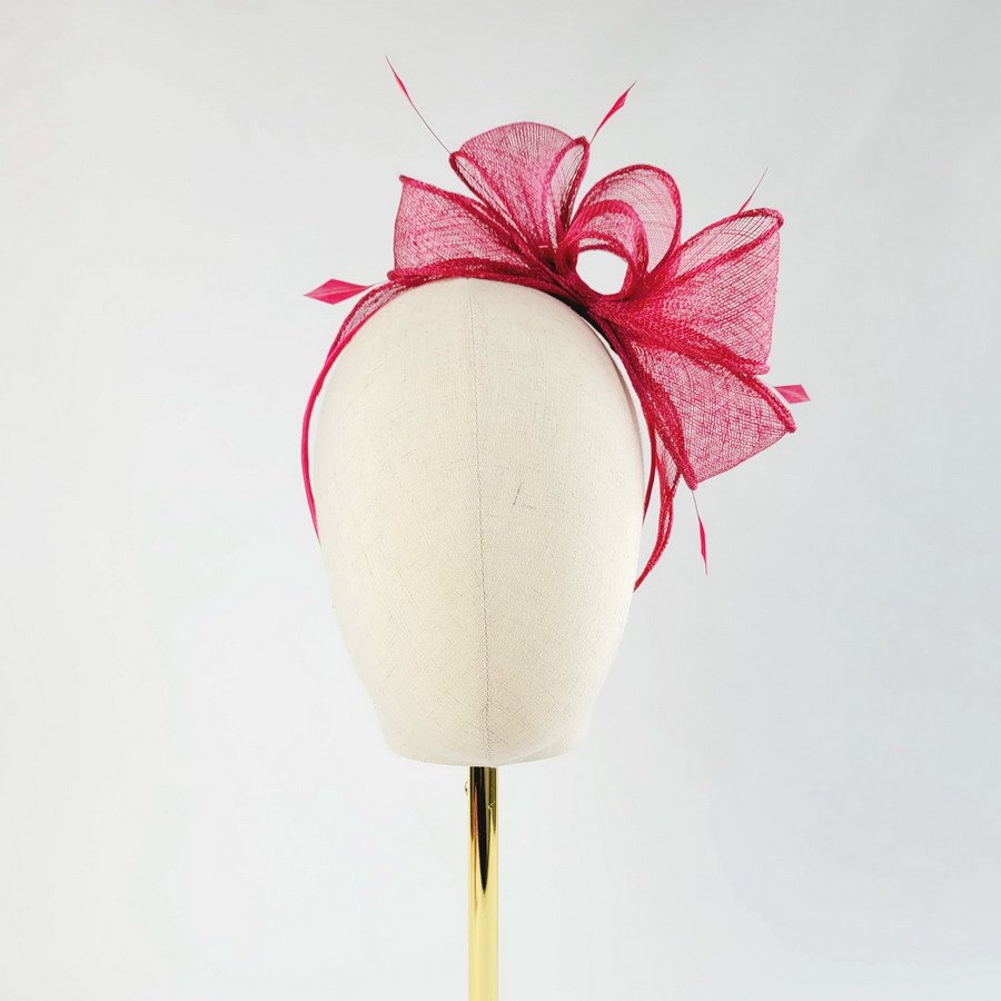 Fuchsia Pink Loop Fascinator with Coque Feathers, worn to the left