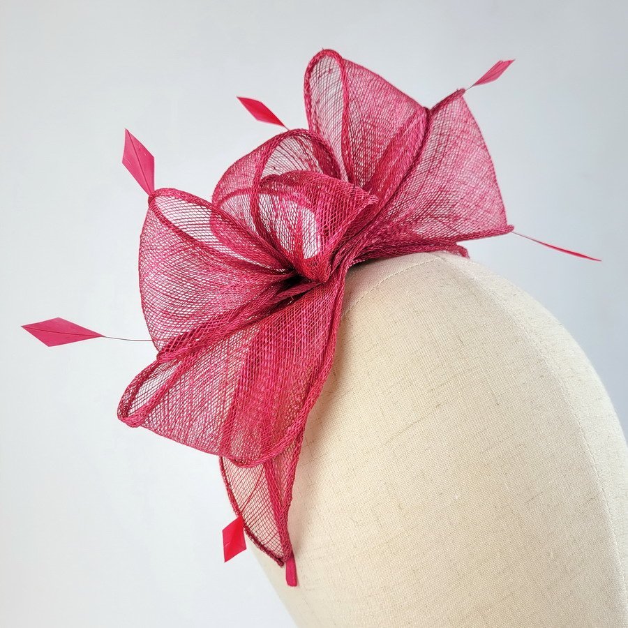 Fuchsia pink fascinator featuring sinamay loops and hand-cut coque feathers