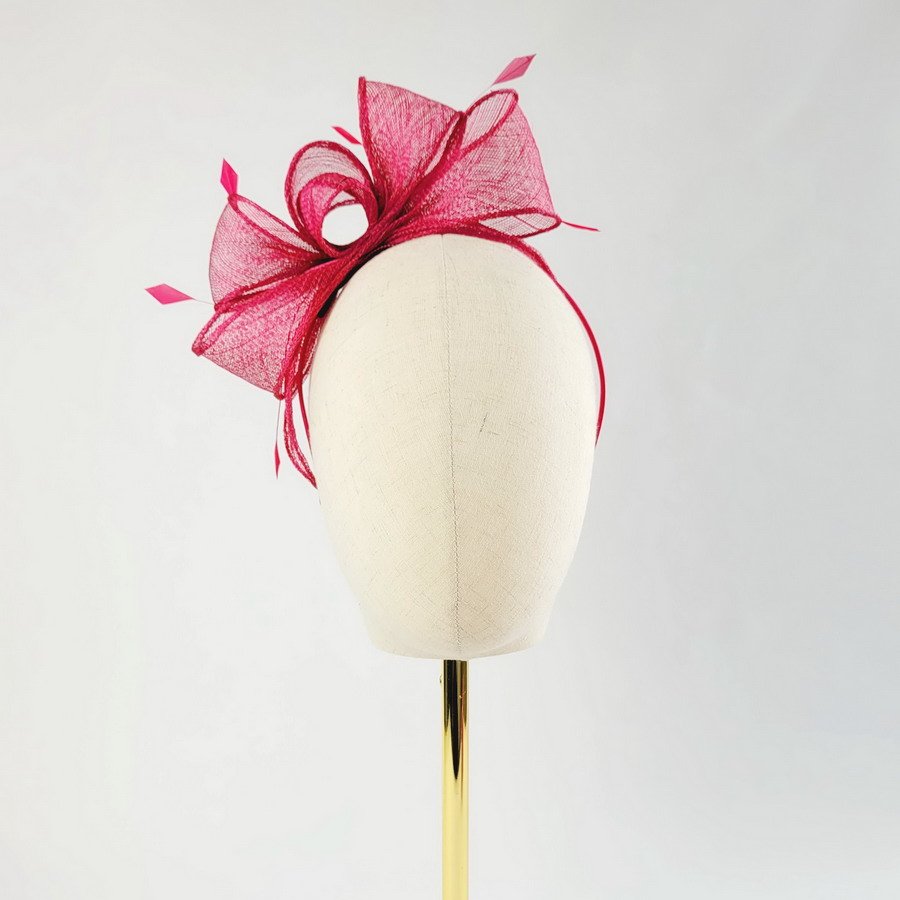 Fuchsia Pink Loop Fascinator with Coque Feathers, worn to the right