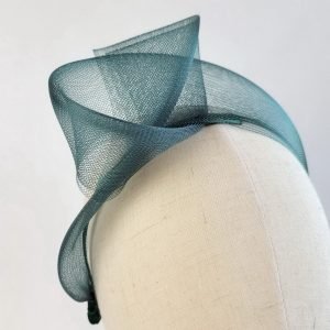 Dark Green statement knot headband worn to the right of the head