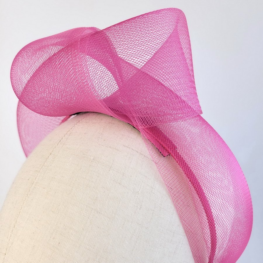 Detail of Dark Pink Crinoline Knot Headband worn to the left of the head