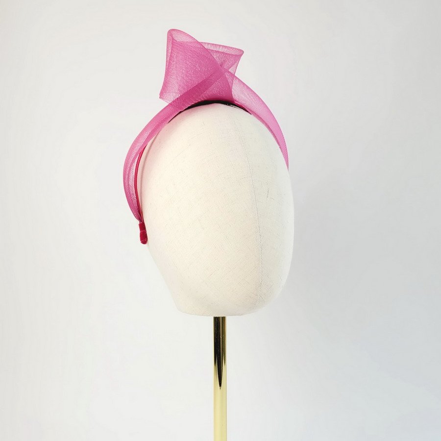 Dark Pink vegan friendly knotted headband worn to the right of the head