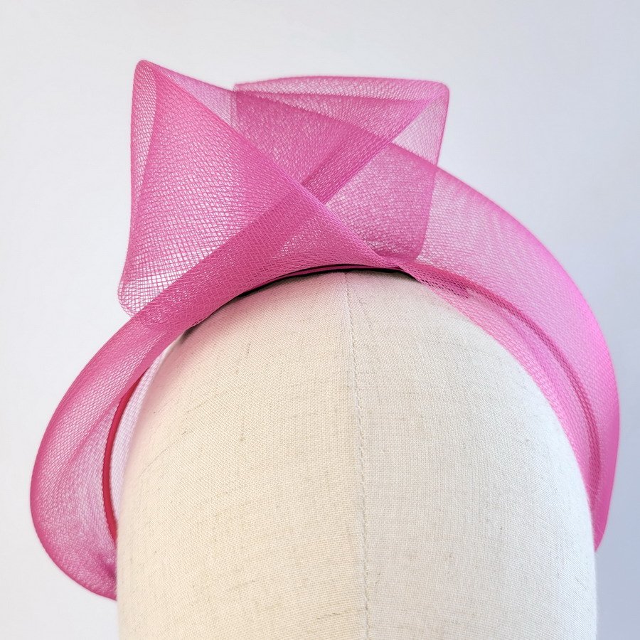 Dark Pink statement knot headband worn to the right of the head