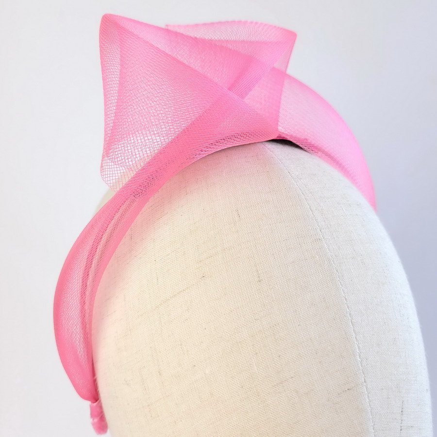 Fuchsia statement knot headband worn to the right of the head