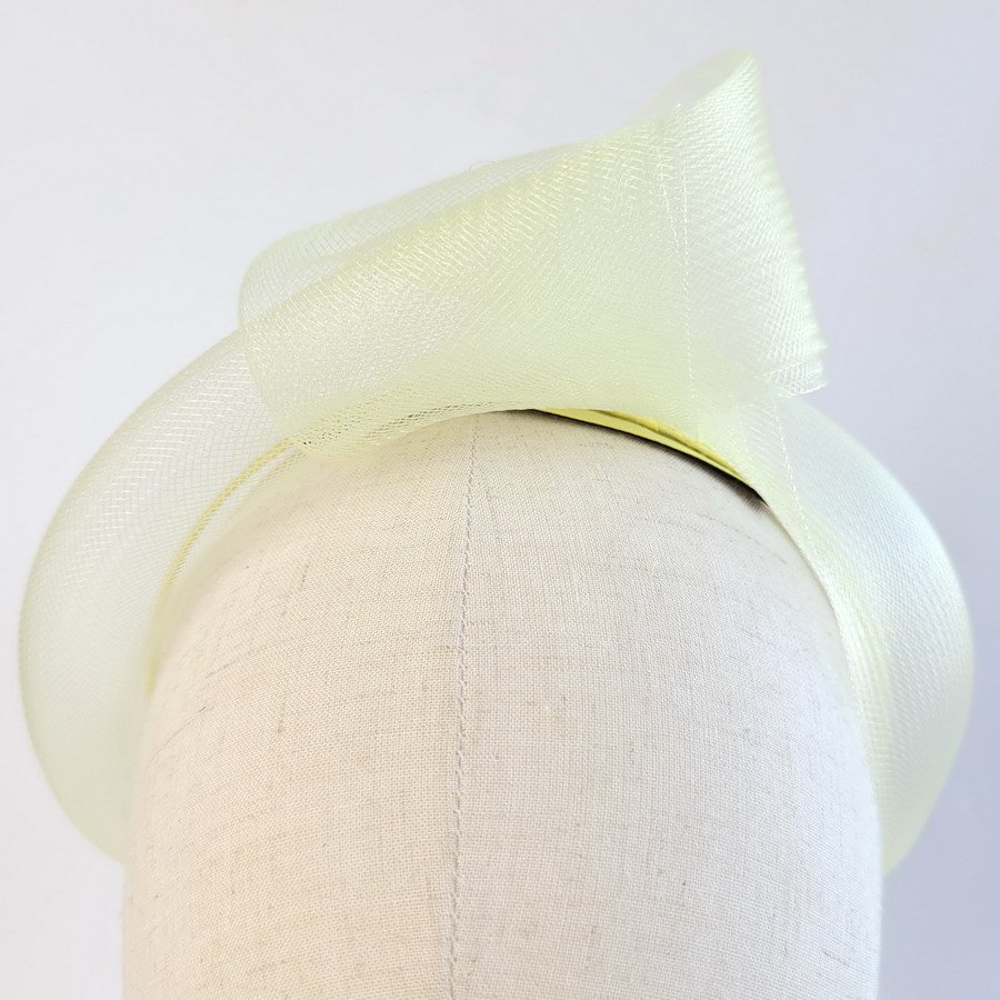 Detail of Pale Yellow Crinoline Knot Headband worn to the left of the head
