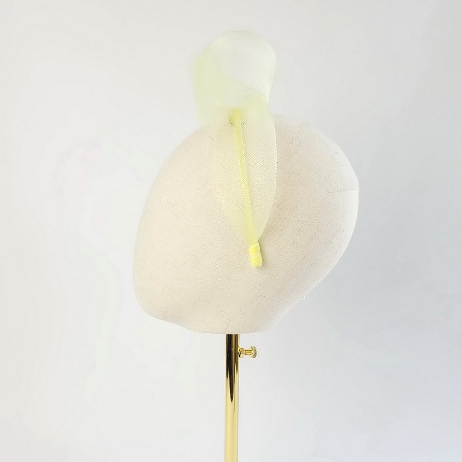 Pale Yellow contemporary headband worn to the left of the head