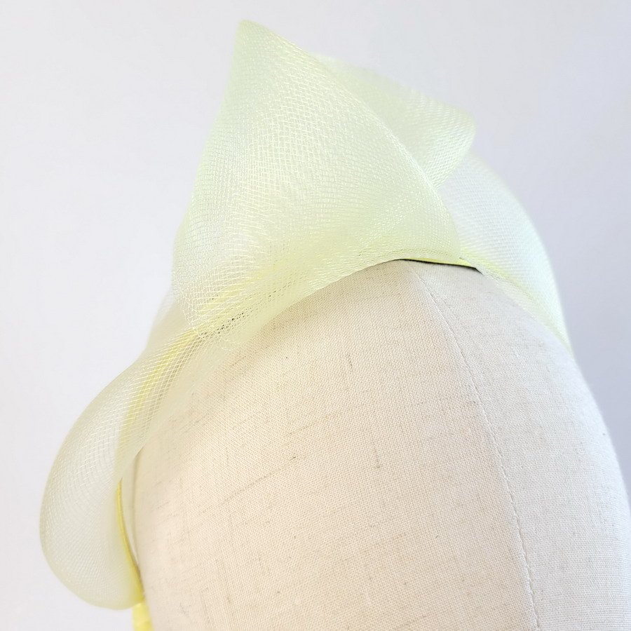 Detail of Pale Yellow Crinoline Knot Headband worn to the right of the head