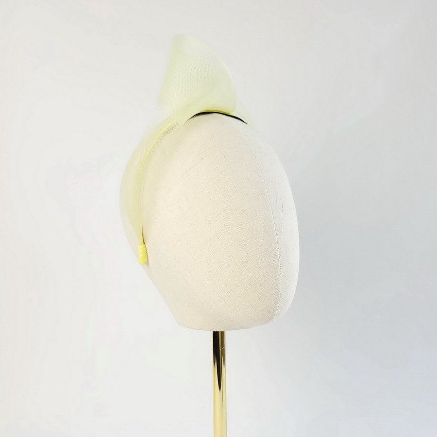Pale Yellow vegan friendly knotted headband worn to the right of the head