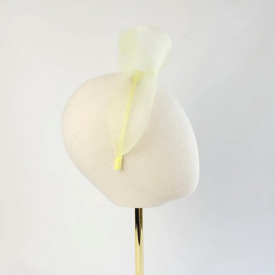 Pale Yellow statement knot headband worn to the right of the head