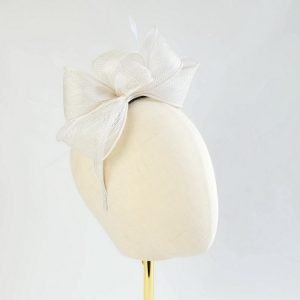 White Loop Fascinator with Coque Feathers worn to the right of the head