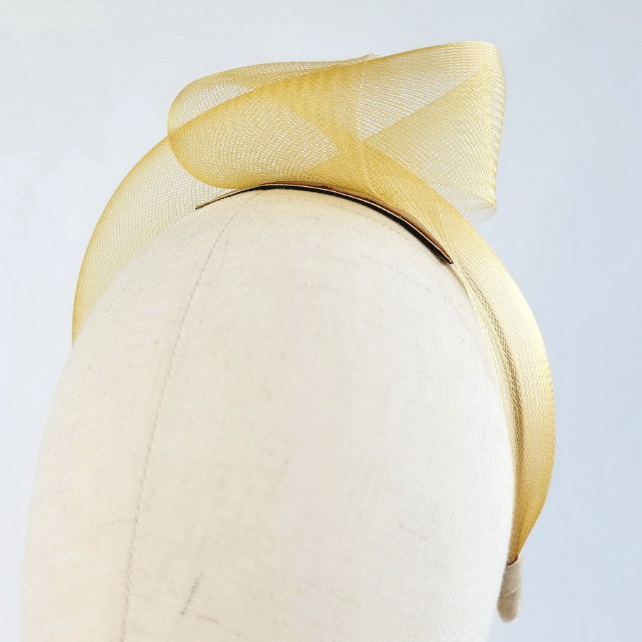 Detail of Mustard Crinoline Knot Headband worn to the left of the head