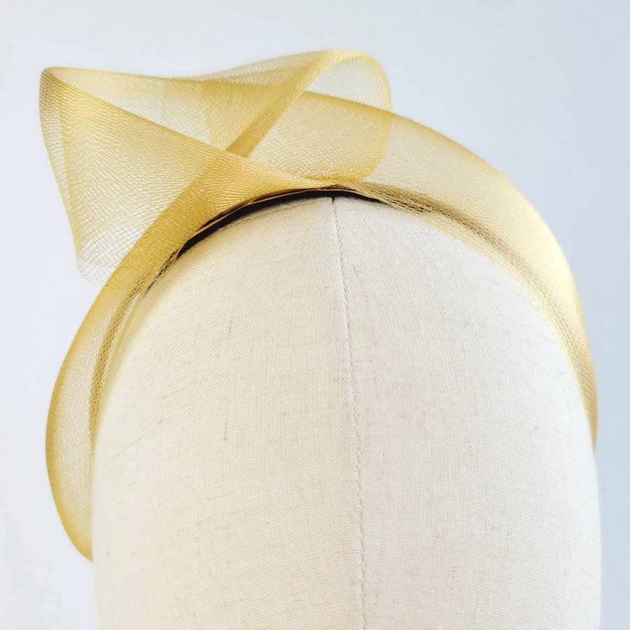 Detail of Mustard Crinoline Knot Headband worn to the right of the head