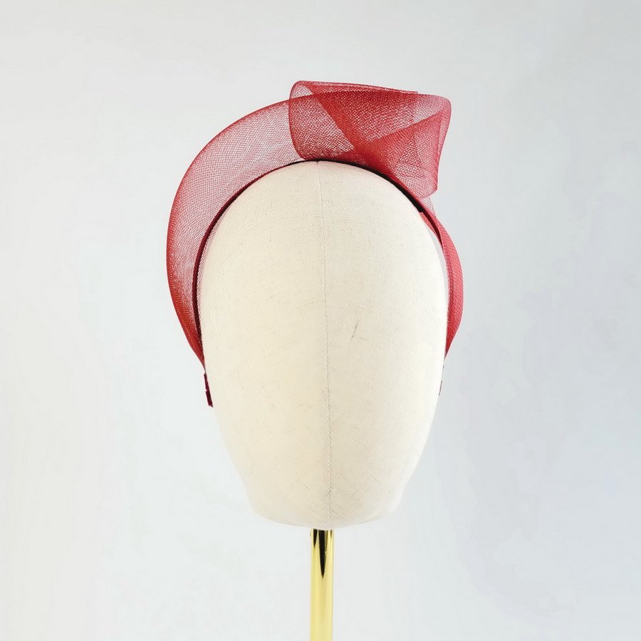 Wine Red contemporary headband worn to the left of the head