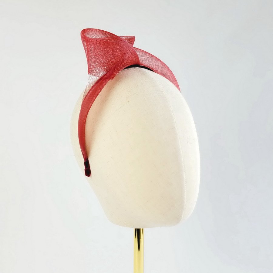 Wine red statement knot headband worn to the right of the head