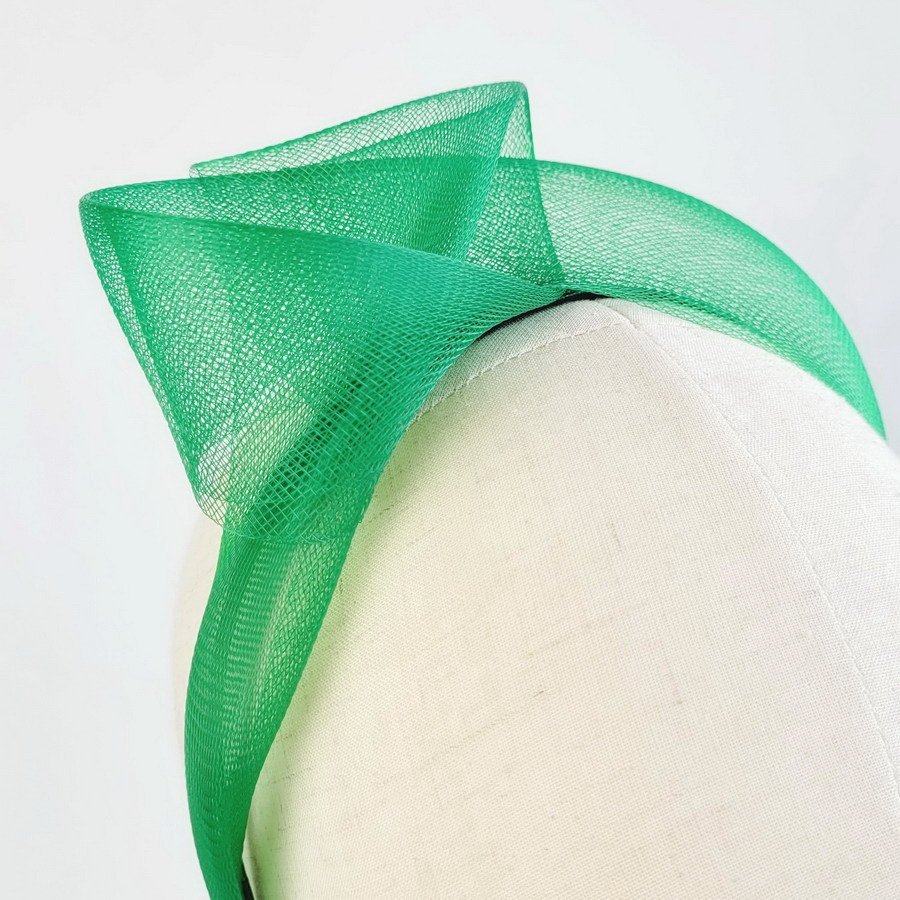 Detail of Emerald Green Crinoline Knot Headband worn to the right of the head