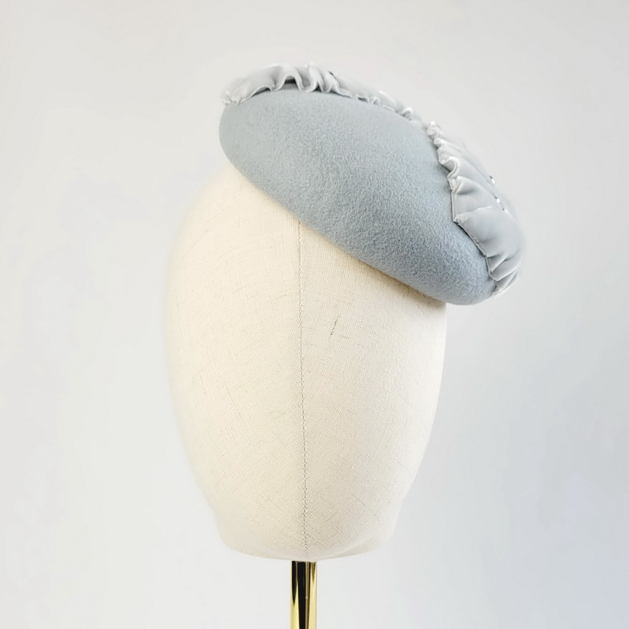 Ice Blue Felt Button with Velvet Leaves and Pearls worn to the left of the head