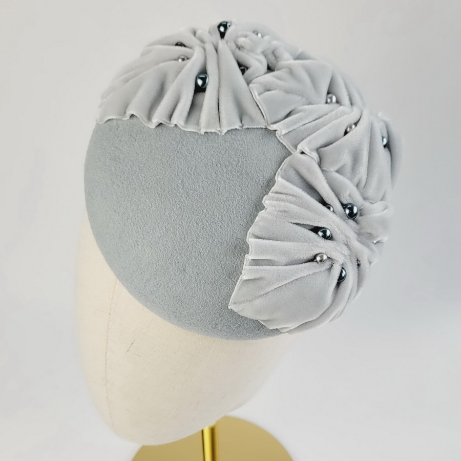 Ice Blue Felt Button with Velvet Leaves and Pearls worn to the left of the head