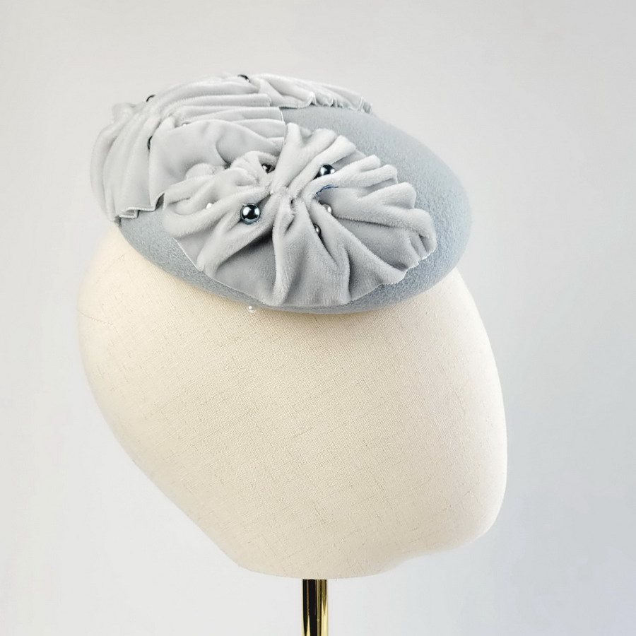 Ice Blue Felt Button with Velvet Leaves and Pearls worn to the right of the head