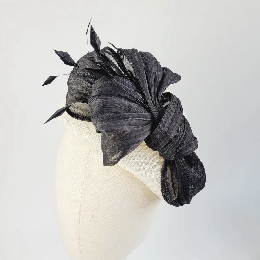 Ivory and black hat with feathers for a wedding guest
