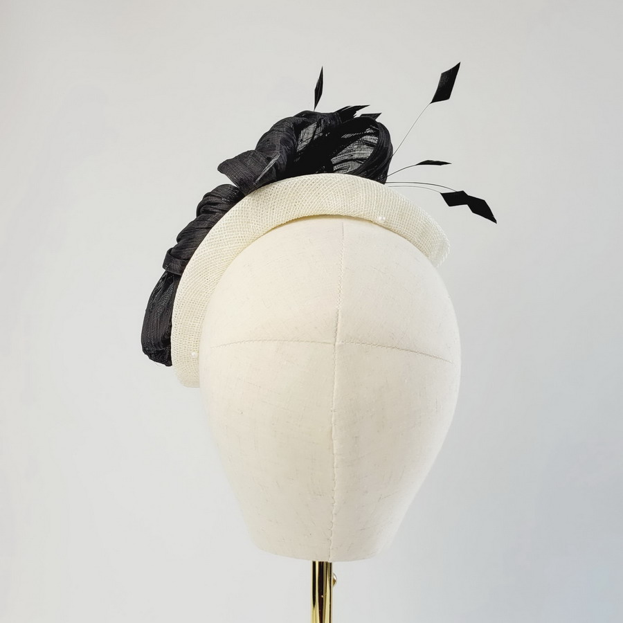 Back view of an ivory occasion hat with black decoration perfect for all formal occasions