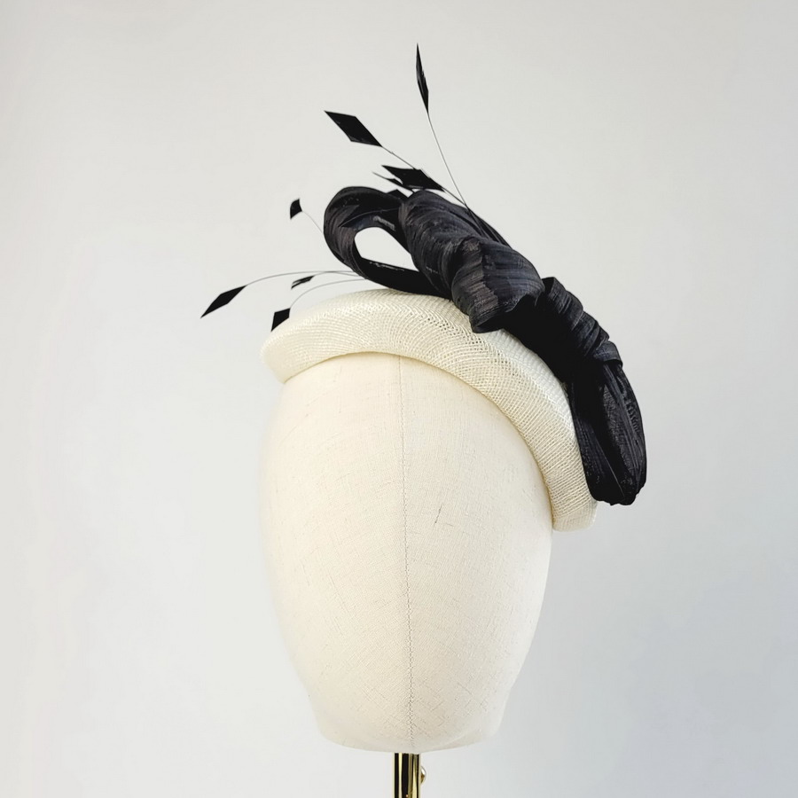 Ivory Half Hat with Black Abaca Loops and Coque Feathers worn to the left of the head