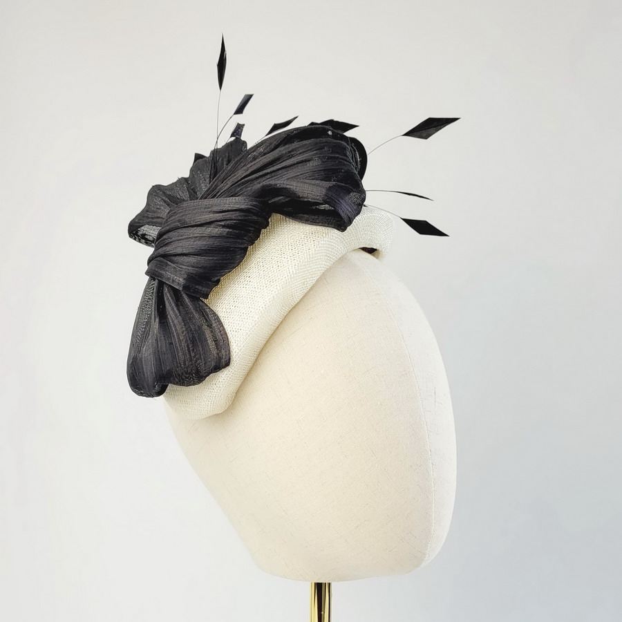 Ivory Half Hat with Black Abaca Loops and Coque Feathers worn to the right of the head