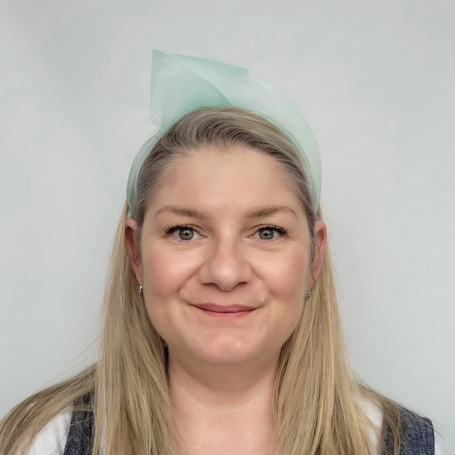 Aqua Blue Crinoline Knot Headband worn by a model in her 40s with long blonde hair