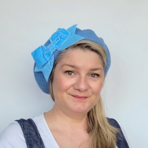 Cornflower Blue Beret with Blue Velvet Ribbon Bow worn by a white woman in her 40s with long blonde hair