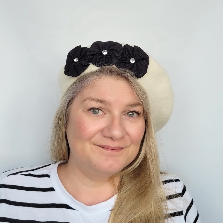 Grey Beret with Ribbon Rosettes and Diamante worn by a white woman in her 40s with long blonde hair