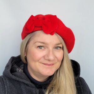 Red Beret with Red Velvet Bow worn by a white woman in her 40s with long blonde hair